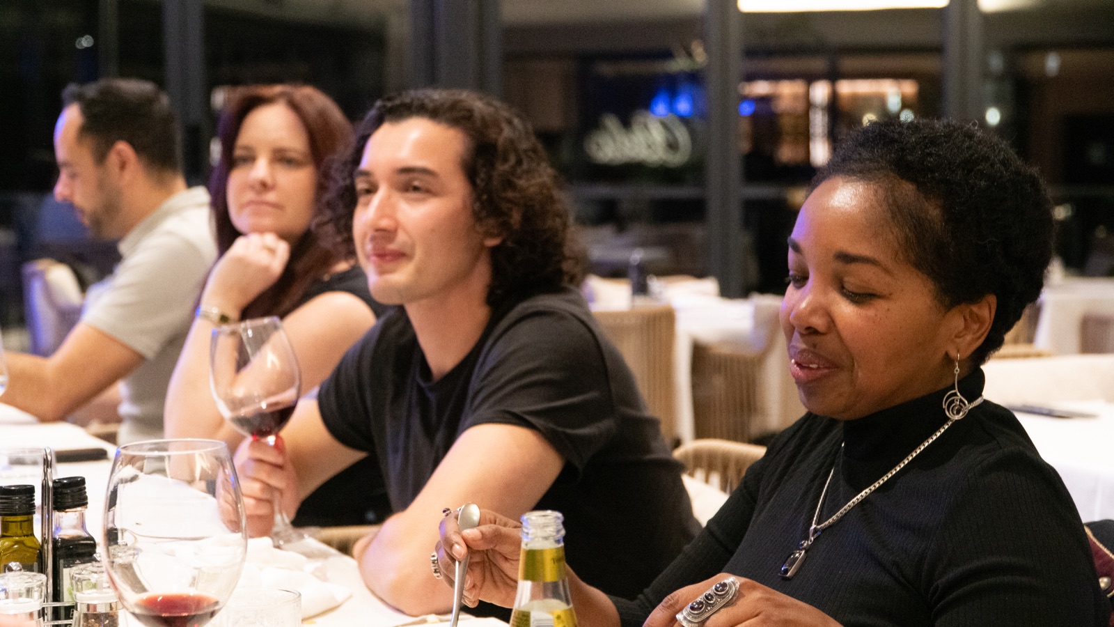 Nomio residents sharing a Friday Table dinner